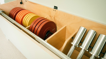 A look inside the Fittle Box, filled with dumbells, barbells, and colourful weights.