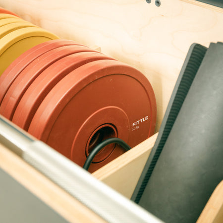 Close up image of a Fittle box 5kg plates and bench mat 