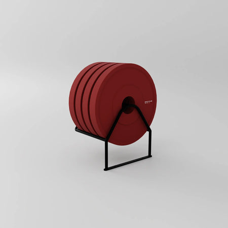 Red 5 kg Fittle weight plates arranged on a bespoke black storage rack (Plus Pack) against a plain background