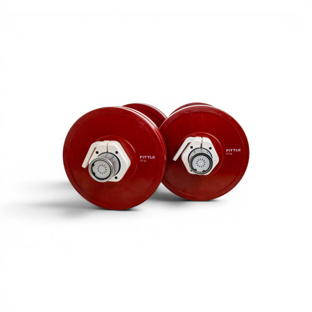 Two red adjustable dumbbells on a white background.