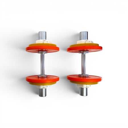 Two Fittle adjustable dumbbells with orange and yellow weights on a white background.