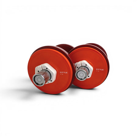 Pair of adjustable Fittle dumbbells with weights on a white background. 