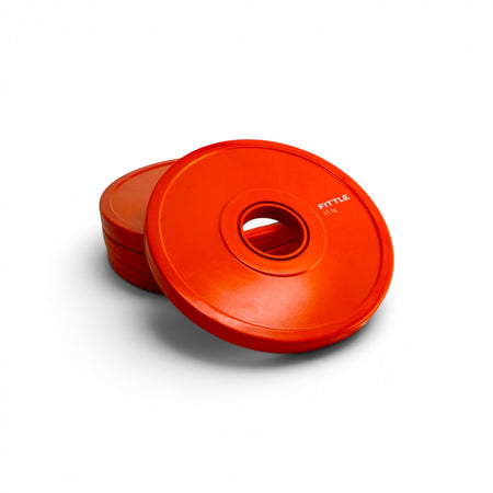 4 orange weight plates on a white background.